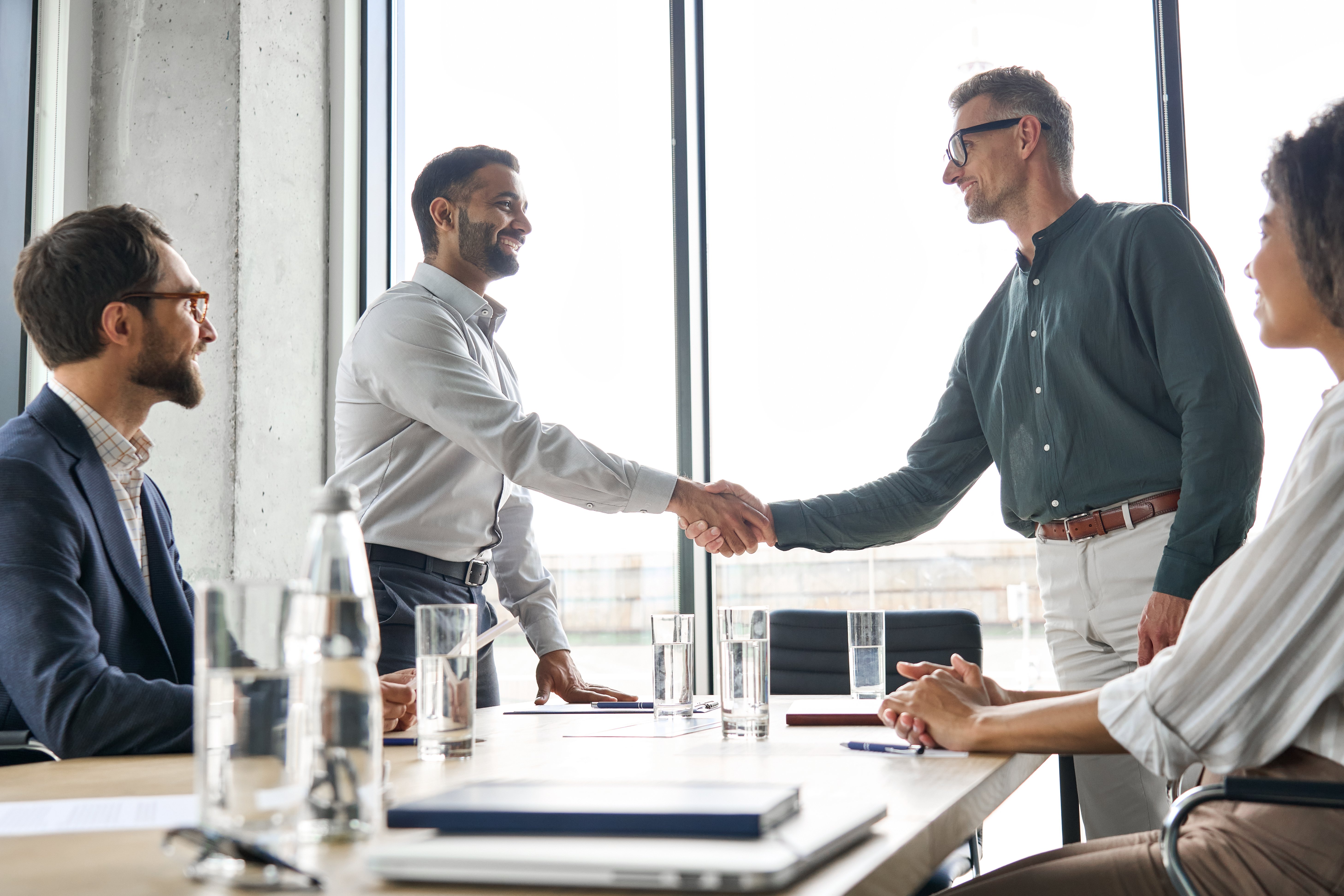 Business handshake after a successful lead conversion conversation